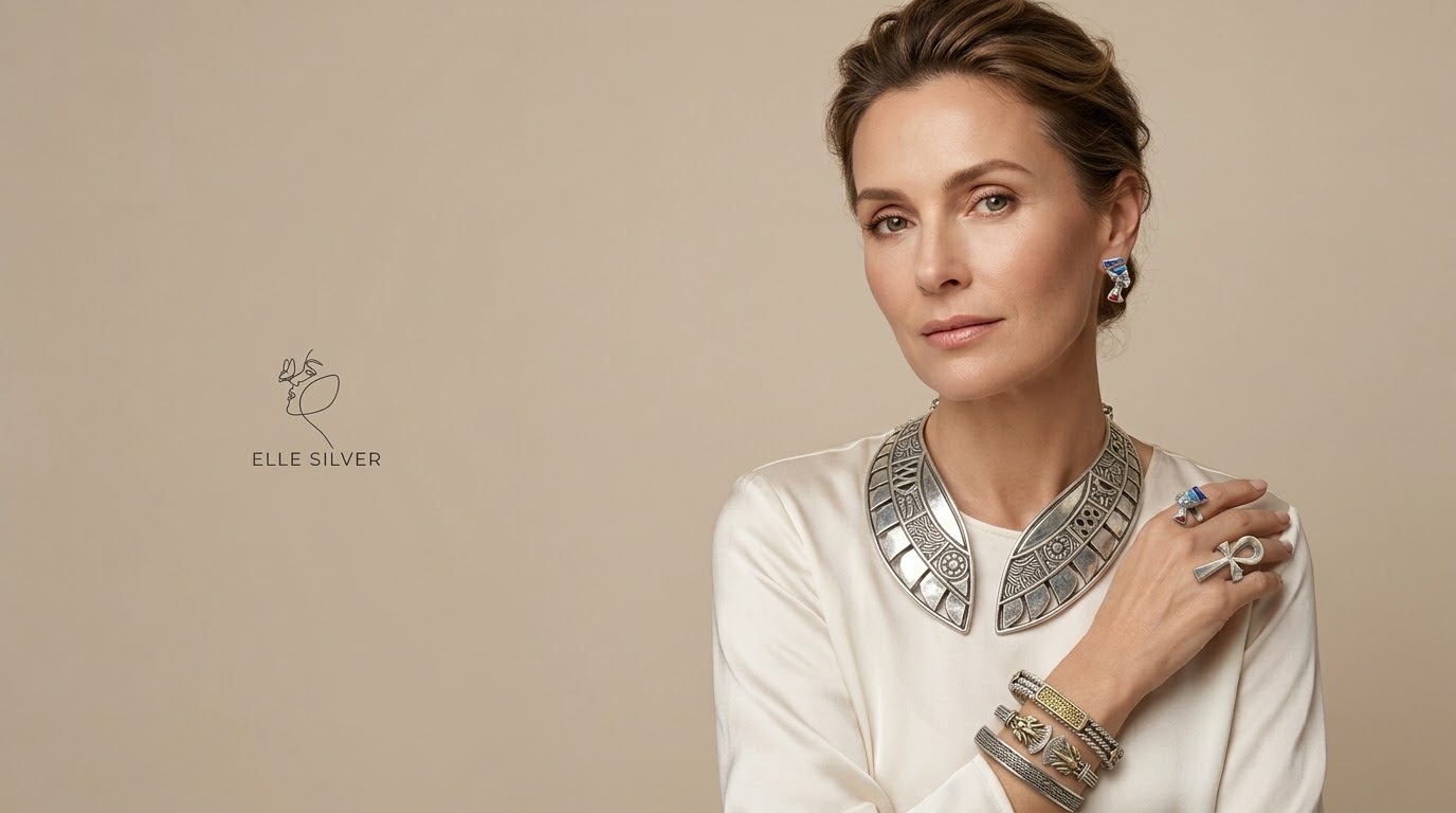 A woman in an ivory top wearing silver jewelry from Elle Silver Shop: a collar necklace, bracelets, a ring and earrings